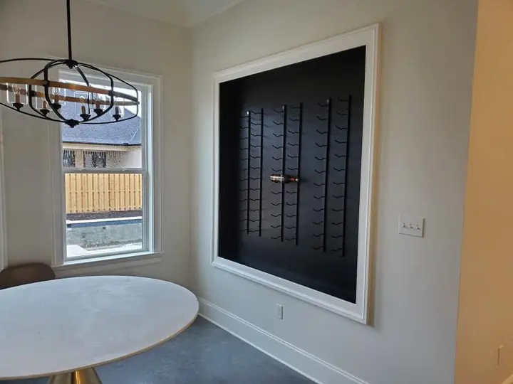 Built-in wall-mounted wine rack framed in white trim