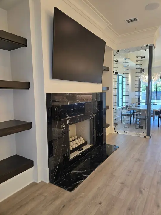 Modern black marble fireplace surround with floating shelves
