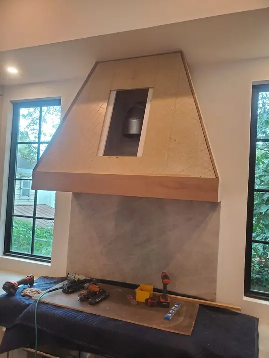 Custom wood-wrapped kitchen range hood under construction