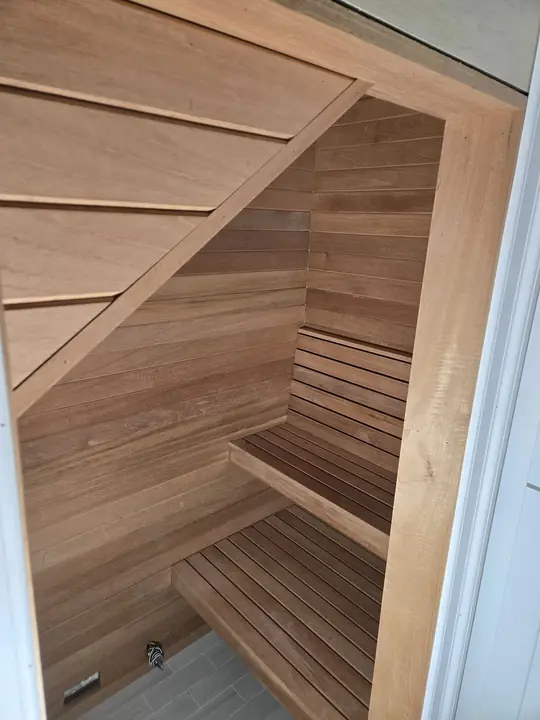 Cedar sauna interior with angled slatted bench seating