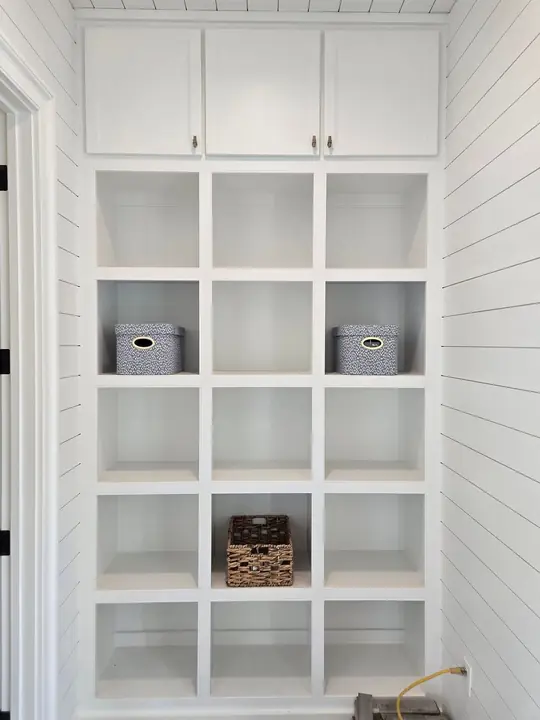 White built-in mudroom cubbies and cabinetry