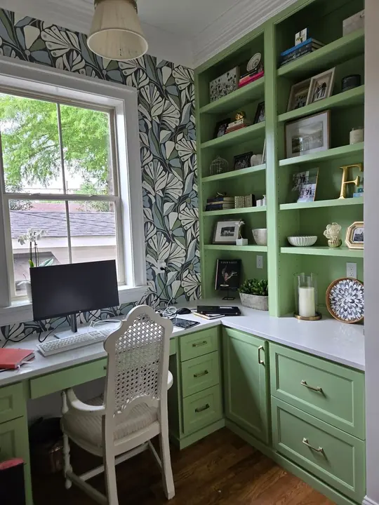 Custom built-in home office desk and bookshelves with painted green cabinetry