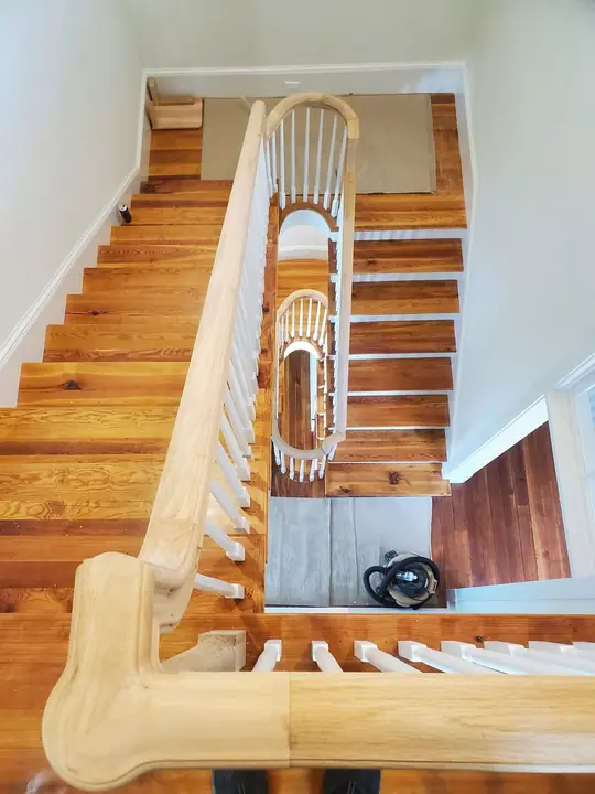 Overhead view down a curved staircase with oval landings