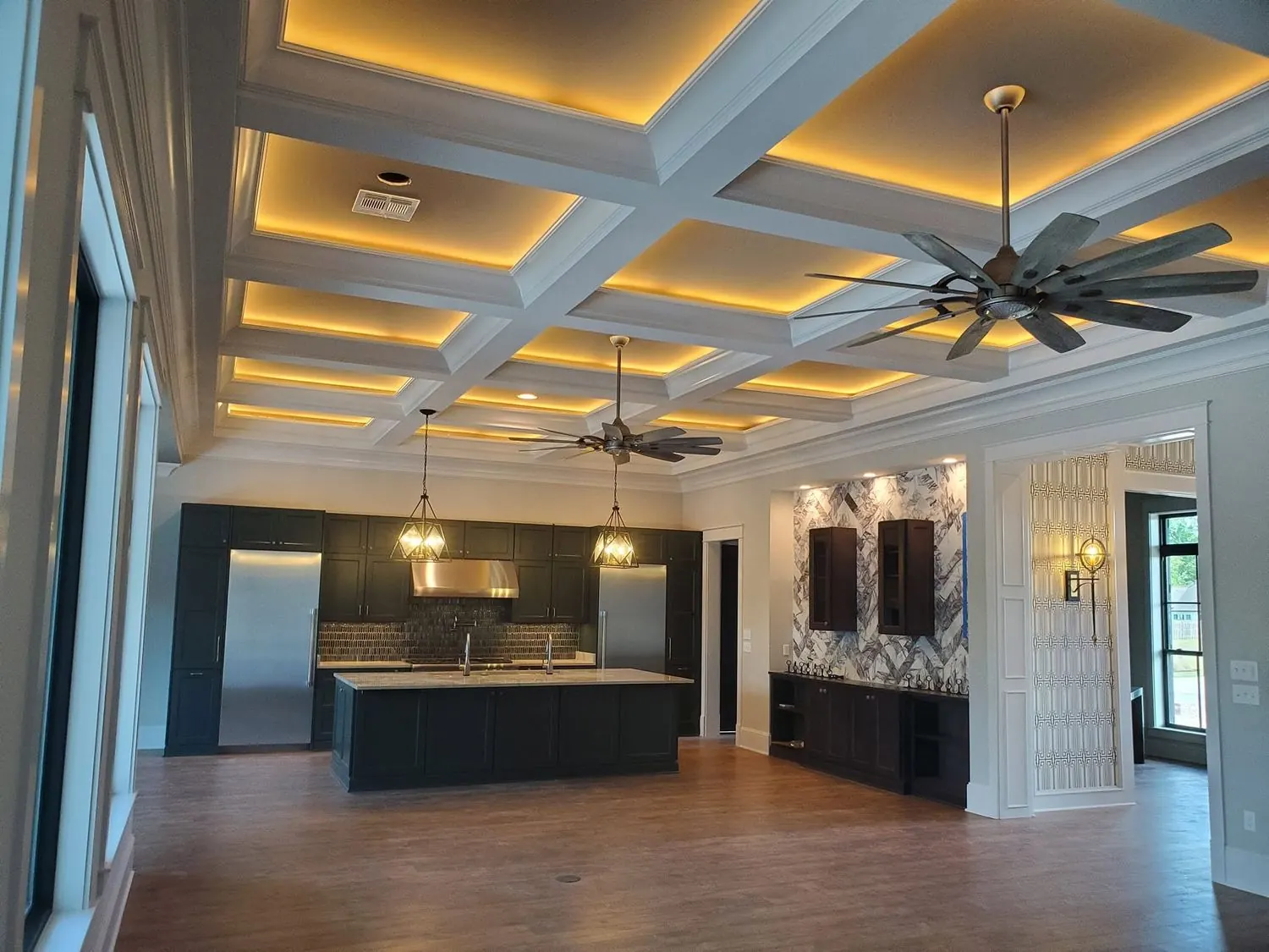 Finished kitchen with coffered ceiling and custom cabinetry